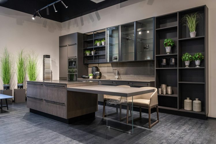pexels-photo-6969873-6969873-1 Sleek modern kitchen featuring a spacious island, indoor plants, and elegant shelving.